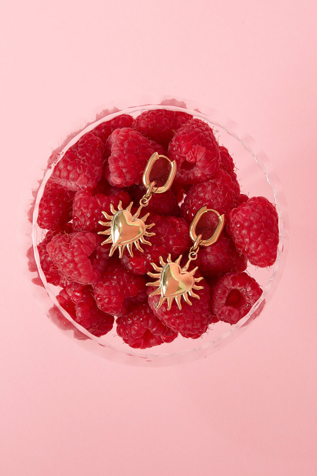 Boucles d'oreilles avec des cœurs pendants et des rayons de soleil