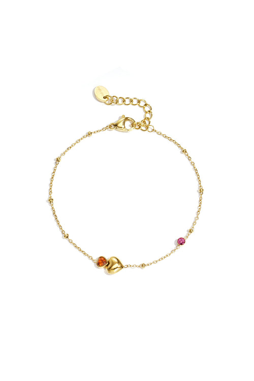 Bracelet orné de cœurs, de pierres colorées et de pois