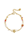 Bracelet à breloques orné de breloques en forme d'étoile et de fleur, de perles, de pierres et de perles de rocaille